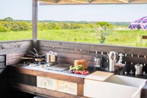 a kitchen counter with a stove and a sink at Luxury glamping in Constable Country - Valley View Yurt 