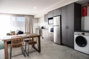 a kitchen with a table and a refrigerator at 107 George in Kalbar