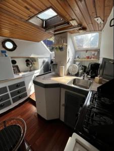 a small kitchen with a sink and a stove at Bateau Watson, vivez l'aventure in Ouistreham