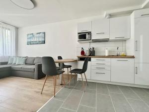 a kitchen and living room with a table and chairs at Premium Apartment by Hi5 - Zamardi One-bedroom in Zamárdi