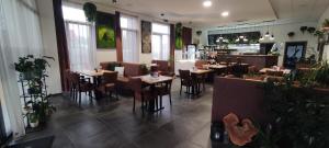 a restaurant with tables and chairs and a bar at U ĽUDMILY - ubytovanie -farmárska predajňa in Cabaj-Čápor