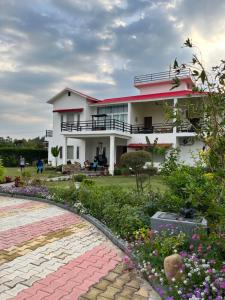 a house with a garden in front of it at Hriday Bhoomi - Luxury Cottages & Villa in Jim Corbett in Jhirna