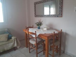 a table with two chairs and a mirror on the wall at Vagelis 2 Nemea apartments in Neméa