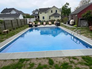 a swimming pool in the backyard of a house at Come As You Are Inn LLC 