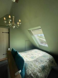 a bedroom with a bed and a skylight at The Stable Loft. NEC, Airport in Fillongley