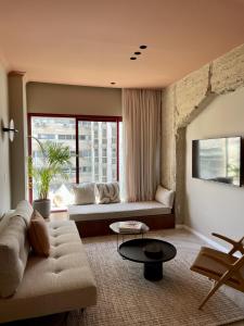 ein Wohnzimmer mit einem Sofa und einem Tisch in der Unterkunft GoodHouse 402 - 4 Bdr beautiful apartment in Jerusalem in Jerusalem