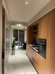 a kitchen with wooden cabinets and a counter top at GoodHouse 402 - 4 Bdr beautiful apartment in Jerusalem in Jerusalem