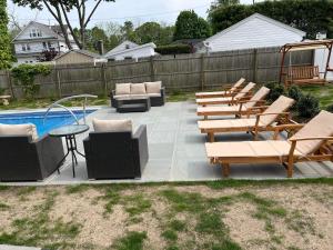 a patio with lounge chairs and a swimming pool at Come As You Are Inn LLC 
