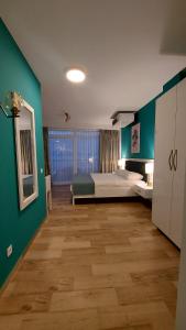 a bedroom with a large bed and a green wall at Pier 82 Apartments in Ohrid