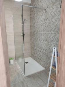 a shower with a glass door in a bathroom at Salina Wharf, Block E, Apt. 26 in St Paul's Bay