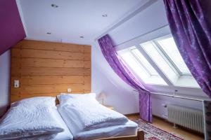 a bedroom with a bed and a large window at NATURION Hotel Hinterzarten in Hinterzarten
