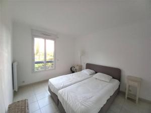 Postel nebo postele na pokoji v ubytování T3 spacieux dans une résidence de standing