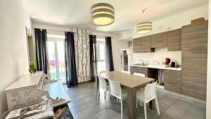 a kitchen and dining room with a table and chairs at Vintage in Alghero