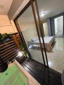 a view of a bedroom with a tub and a bed at Descanso y Confort in Medellín