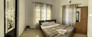Giường trong phòng chung tại Casa Maria Mystica apartments, Mananthavady, Wayanad