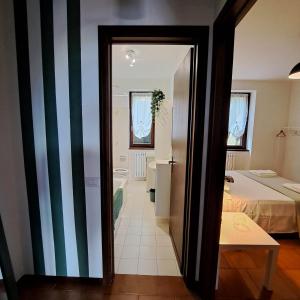 a room with a bed and a door to a bathroom at La casa di Guia in Perledo +15 photos