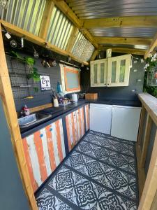 a kitchen with a sink and a counter top at Secret Garden Glamping in Lymington
