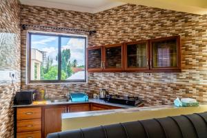 a kitchen with a sink and a window at City Gem by Havana Properties near the French Embassy, Tanzanite Bridge & Coco Beach in Dar es Salaam