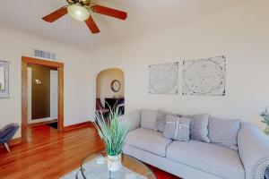 a living room with a couch and a ceiling fan at Historic on 5th in Tucson