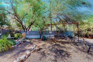 a swing set in a yard with trees at Historic on 5th in Tucson