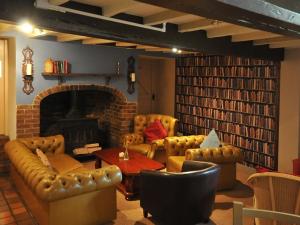 a living room with leather furniture and a fireplace at White Hart Inn in Ironbridge +16 photos