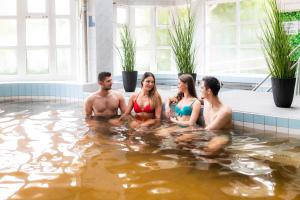 a group of people sitting in the water at Thermal Hotel Garden in Hajdúszoboszló