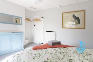 a bedroom with a bed and a picture on the wall at Gerrys Cottage - Quaint Brixham Cottage with Log Burner in Brixham