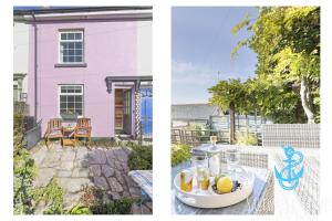 a pink house with a table with a bowl of fruit at Gerrys Cottage - Quaint Brixham Cottage with Log Burner in Brixham