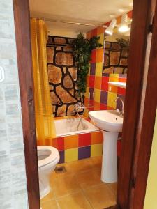 a bathroom with a sink and a toilet and a tub at SeeYou Apartman Agárd in Agárd