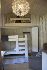a bunk bed in a room with a chandelier at Valldal Camping in Valldal +13 photos