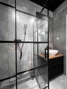 a bathroom with a shower with a sink at Property Apart – Legnicka Business Center in Wrocław
