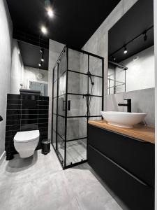 a bathroom with a white toilet and a sink at Property Apart – Legnicka Business Center in Wrocław
