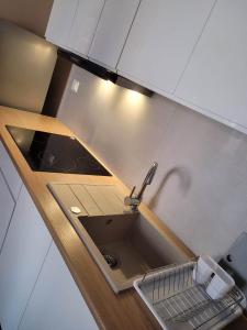 a small kitchen with a sink and a counter top at Apartament Słowińców 35 in Wejherowo