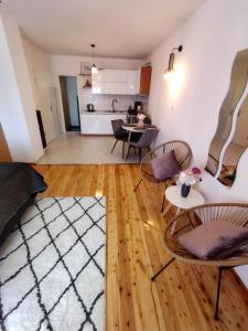 a living room with chairs and a table and a kitchen at Apartments Marina in Hvar