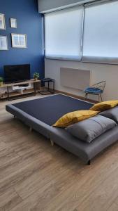 a large bed in a room with a tv at La Suite de Lily in Talence