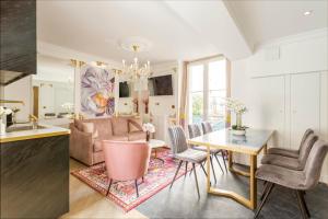 a kitchen and living room with a table and chairs at Luxury 2 Bedroom Eiffel-Tower with Terrace in Paris