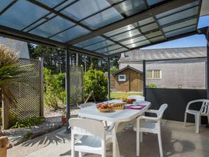 een patio met een witte tafel en stoelen bij Holiday Home Rève de Plage by Interhome in Santec +11 foto's