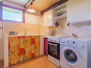 a kitchen with a washing machine and a sink at Holiday Home Le Buis - RSB101 by Interhome in Roche-Saint-Secret