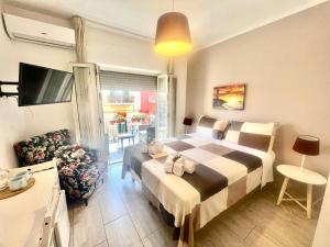 a bedroom with a large bed and a living room at A Casa dei Bruno B&B in Pozzuoli