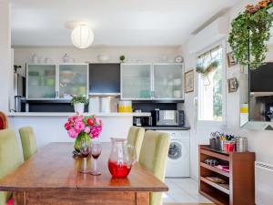 a kitchen with a wooden table with wine glasses at Apartment Elisa-1 by Interhome in Trouville-sur-Mer