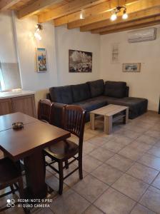 a living room with a couch and a table at Astradeni luxury apartments Vootis in Páloi