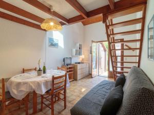 a living room with a dining room table and a staircase at Holiday Home Hameau des Flots by Interhome in Saint-Palais-sur-Mer