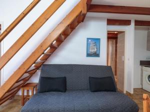 a living room with a couch and a staircase at Holiday Home Hameau des Flots by Interhome in Saint-Palais-sur-Mer