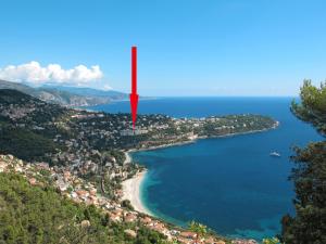a red island in the middle of a body of water at Apartment Parc Massolin - ROQ110 by Interhome in Roquebrune-Cap-Martin