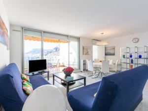 a living room with blue chairs and a blue couch at Apartment Parc Massolin - ROQ110 by Interhome in Roquebrune-Cap-Martin