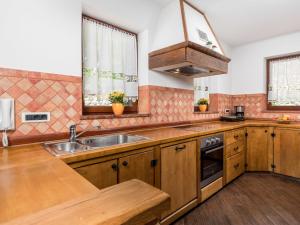 a kitchen with wooden cabinets and a sink at Holiday Home Villa Toni - OPA301 by Interhome in Kastav