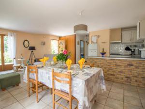 a dining room with a table and a kitchen at Holiday Home Chastagnol by Interhome in Le Chastang