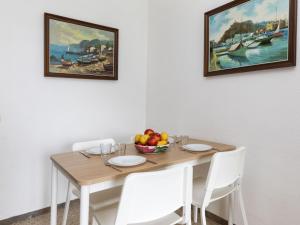 a dining room table with a bowl of fruit on it at Apartment Olivier by Interhome in Blanes