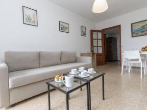 a living room with a couch and a table at Apartment Olivier by Interhome in Blanes