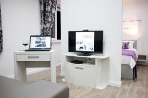 a living room with a tv and a laptop on a table at Apartment 4 You in Split in Split